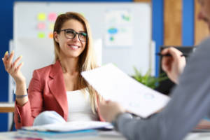 Two adult business people make work interview against office background