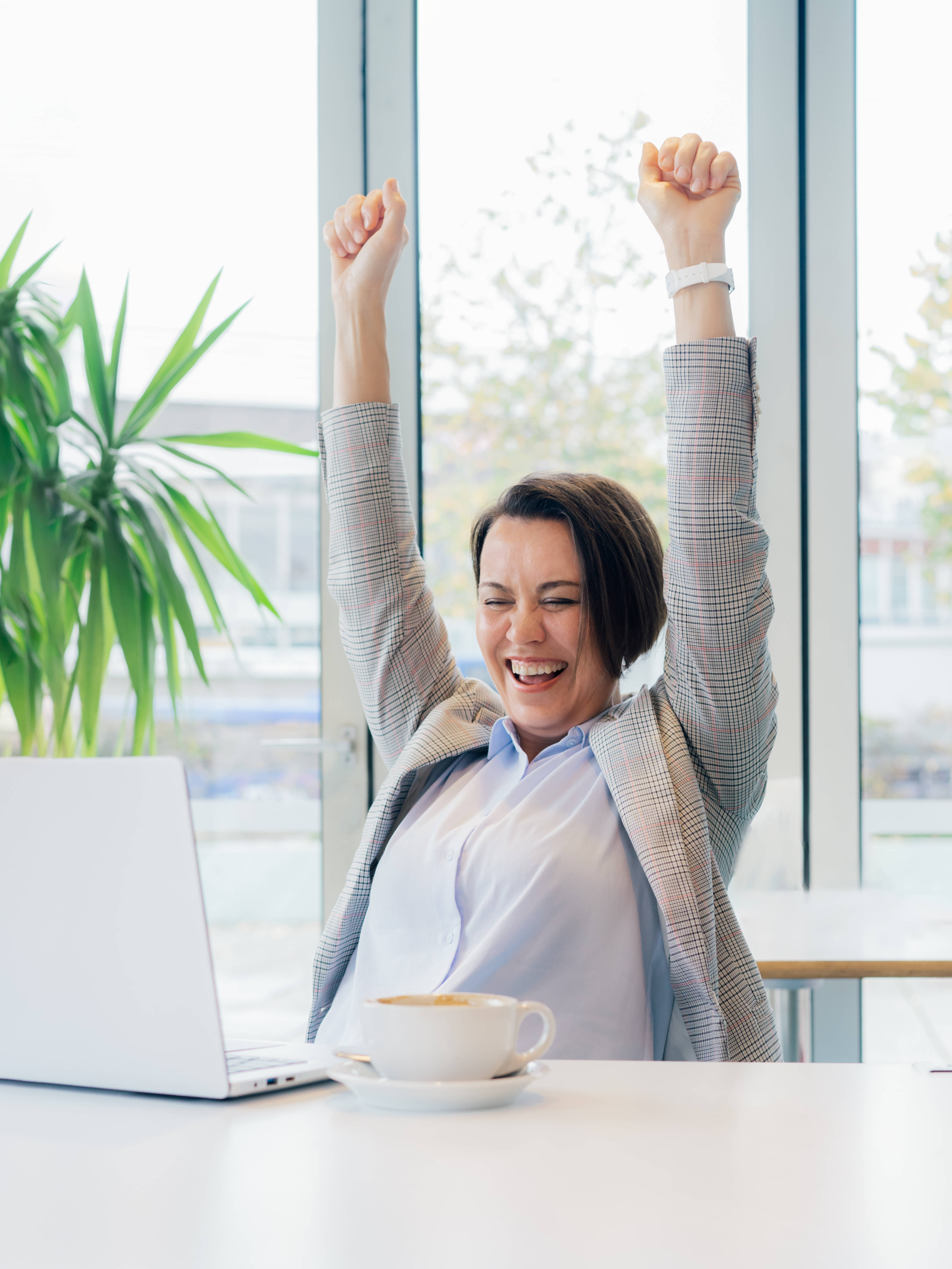 Excited happy middle aged business woman with laptop feeling winner rejoicing online win got new job opportunity, overjoyed motivated lady doing yes gesture, receive good result, celebrating in office