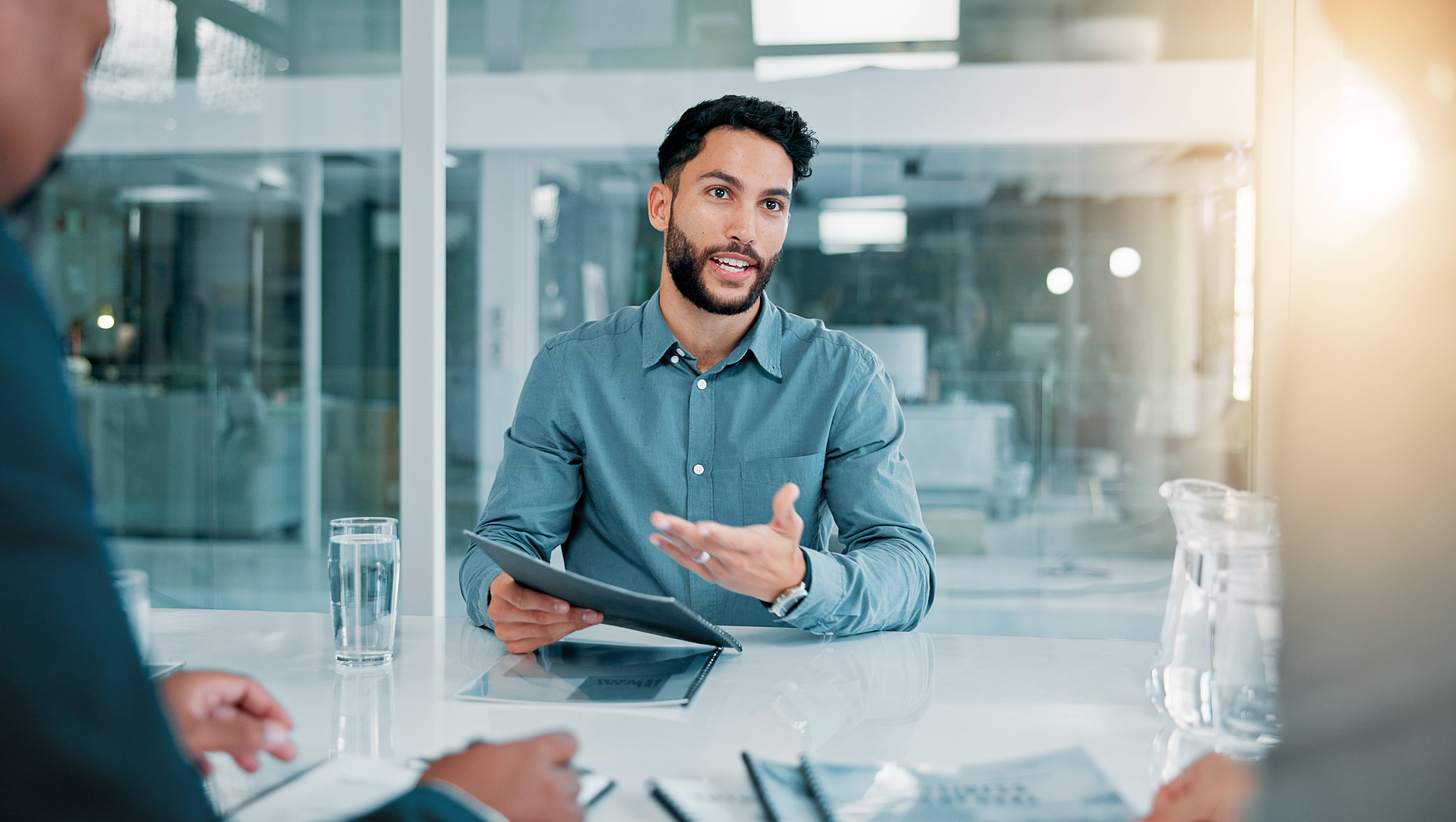 Job interview, discussion and businessman with CV in office for recruitment, opportunity or onboarding. Meeting, human resources and candidate with hiring vacancy in workplace for career growth.